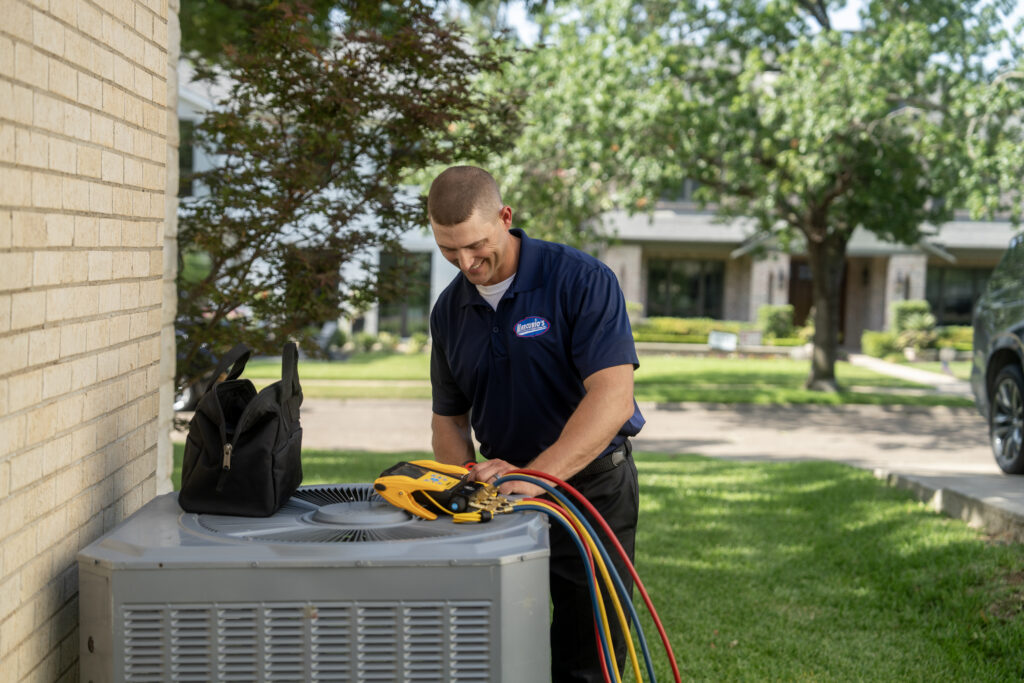 AC technician repairing outside unit