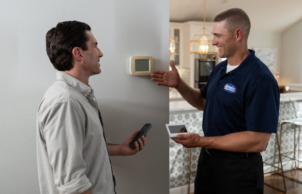 HVAC tech demonstrating smart thermostat