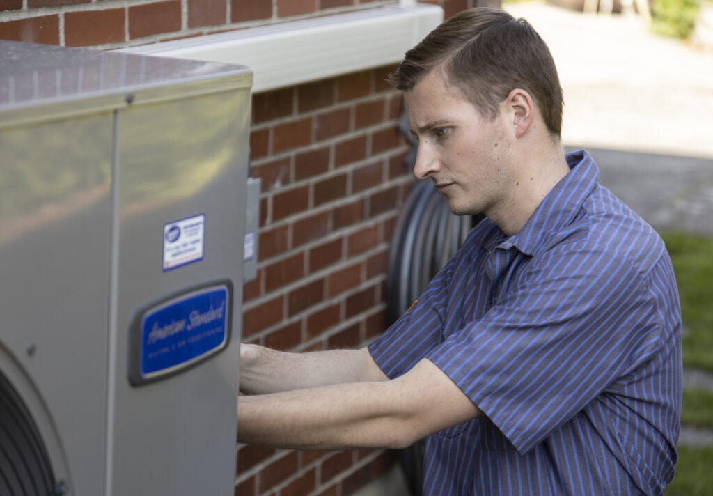 HVAC tech working on an exterior unit