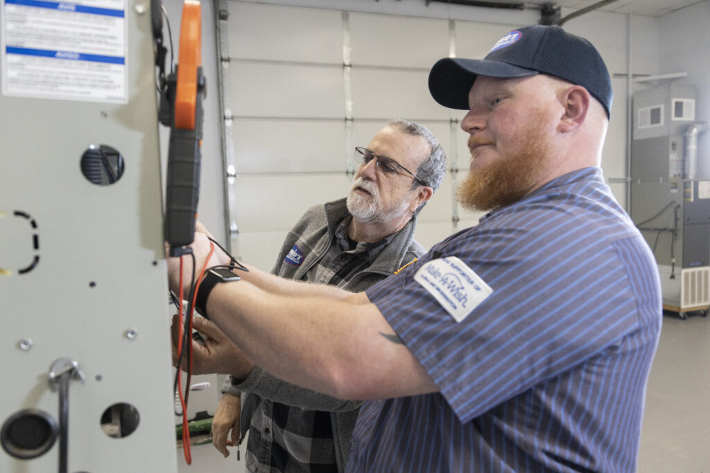 HVAC tech inspecting a furnace
