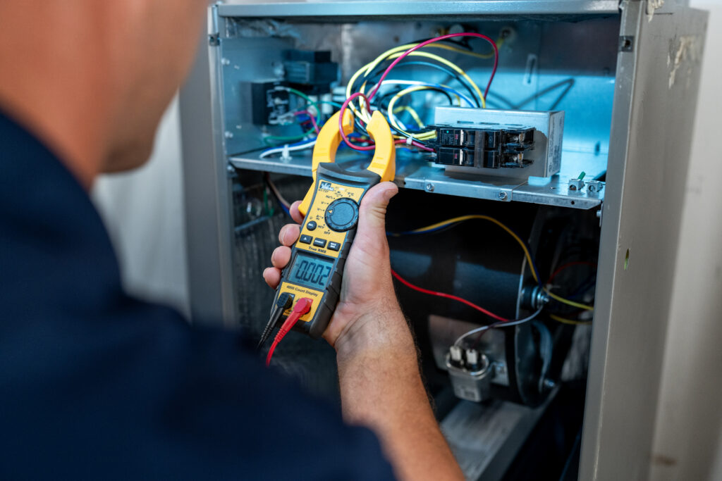 HVAC tech troubleshooting furnace