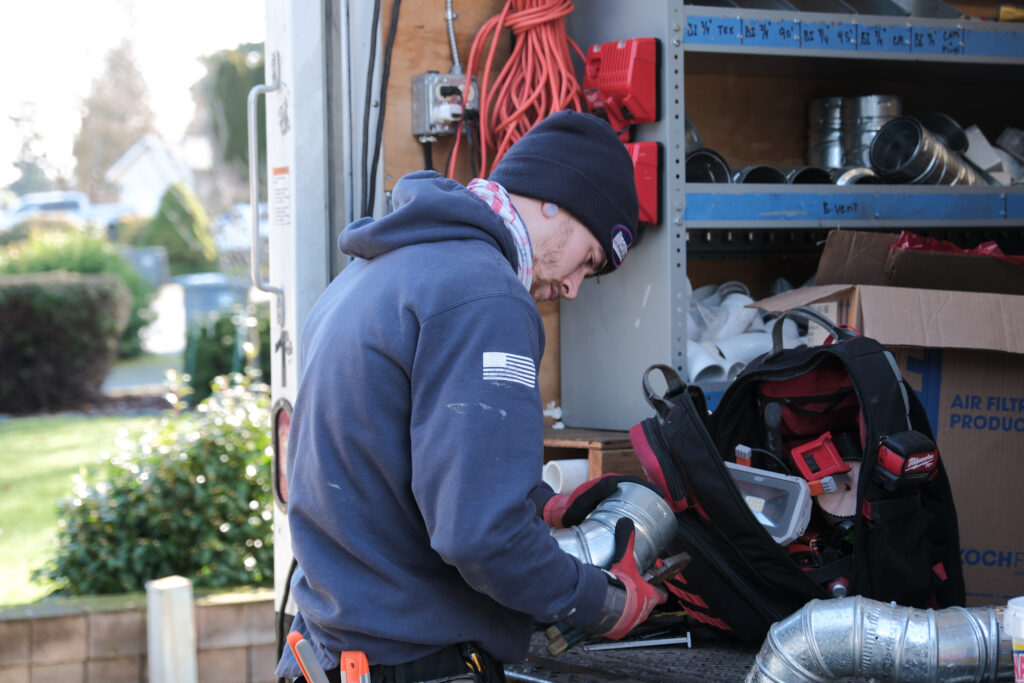 HVAC tech with open van
