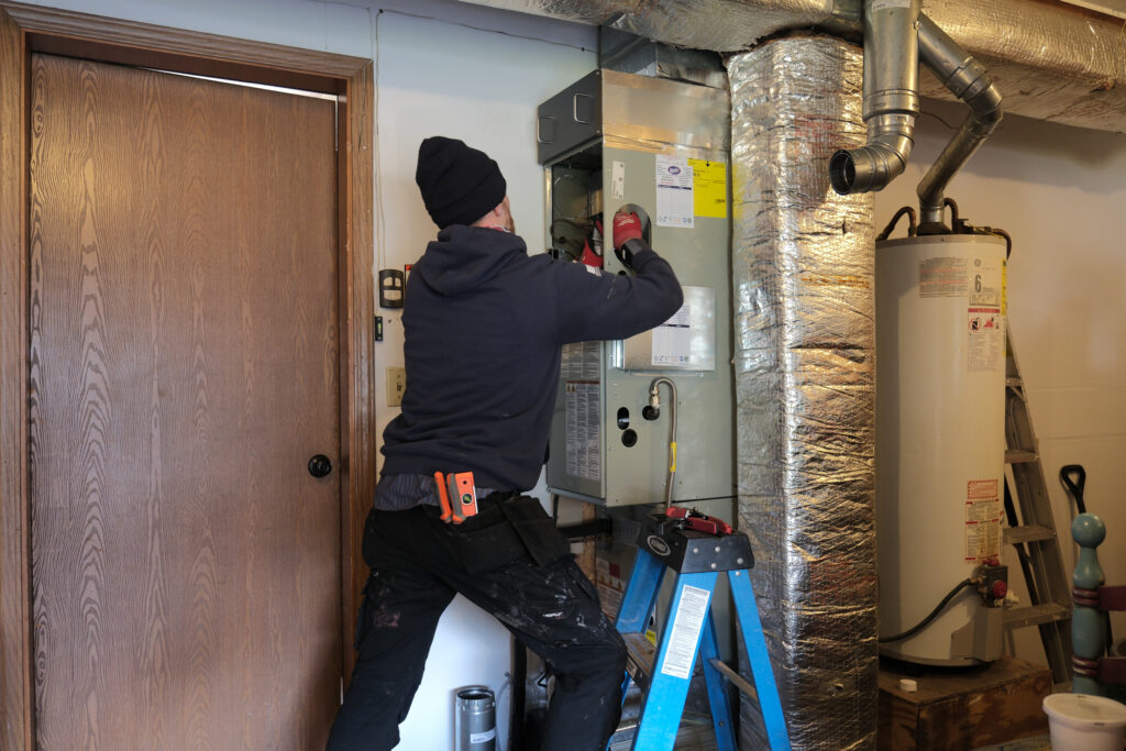 HVAC service tech installing furnace