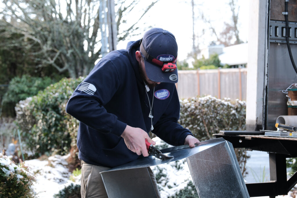 HVAC tech working on ductwork