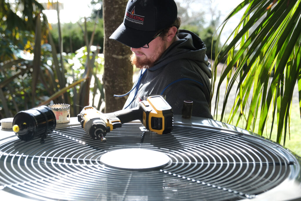 HVAC tech repairing AC