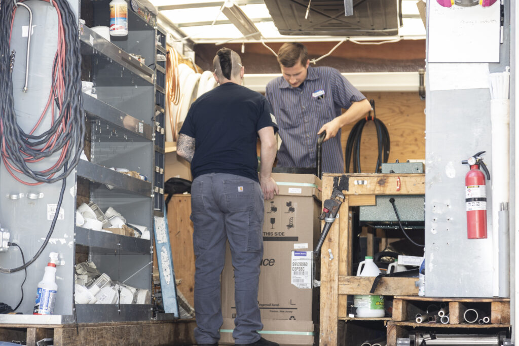 HVAC techs moving furnace
