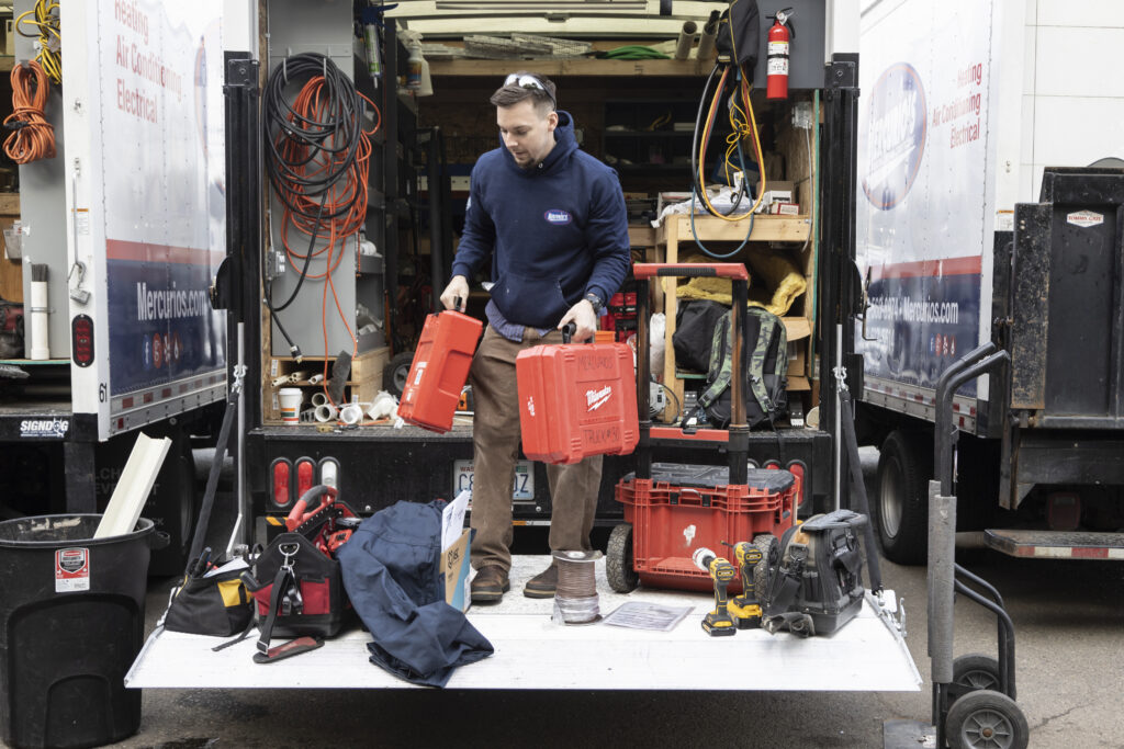 AC repair tech with equipment