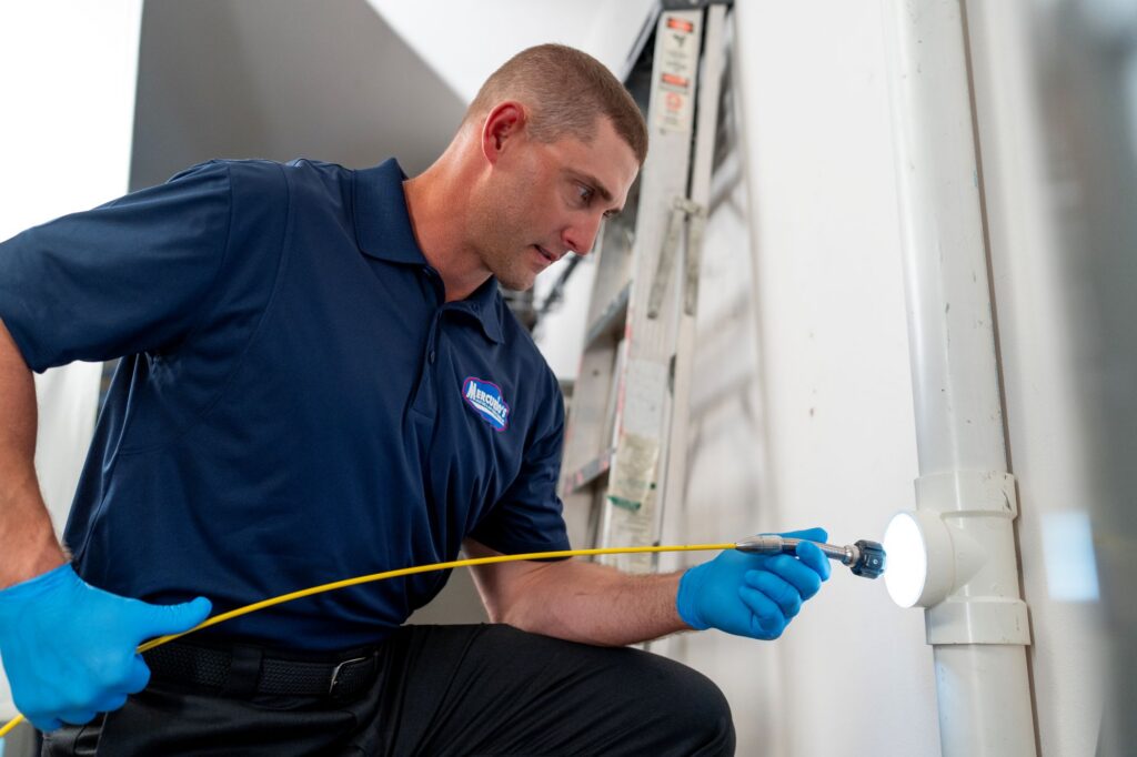plumber working on sump pump system