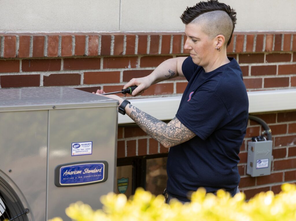 HVAC tech working on heat pump